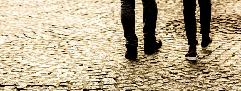 Couple walking on cobblestone
